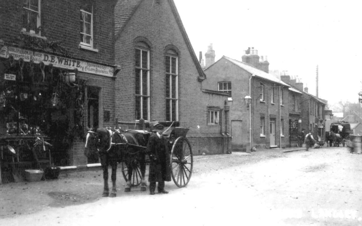 Henderson Hall and the High Street, early 20th century, with a horse and cart outside D.E. White's saddlery
